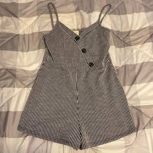 Striped spaghetti strap romper with a button design on the top of it